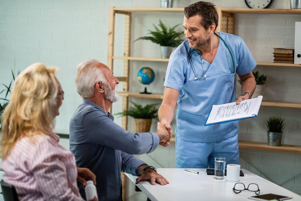 A healthcare professional warmly greets a senior patient with a handshake during a medical consultation, emphasizing a caring and supportive environment.