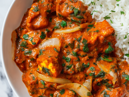 Vegan Tofu Tikka Masala served in a bowl with creamy coconut tomato sauce, golden tofu cubes, Indian spices, and fresh coriander — a rich Indian vegan recipe.
