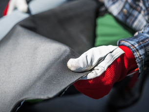 EPDM roof cover vinyl in the roofer's hand.