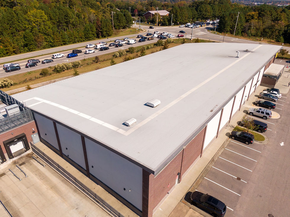 Eye-level view of a white TPO roof membrane installed on a commercial flat roof