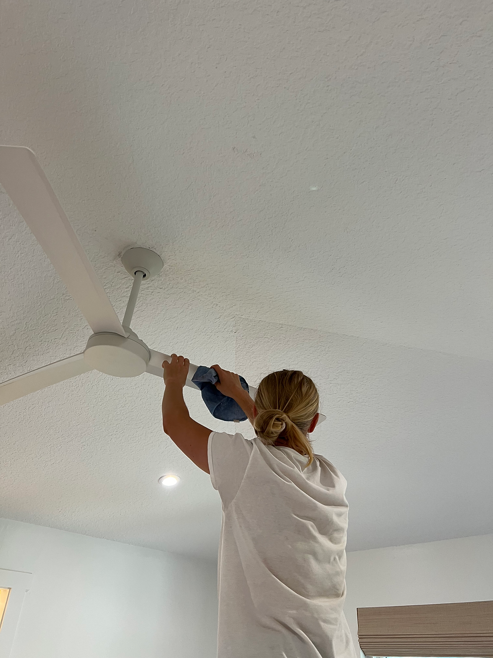 Professional cleaner carefully wiping air vents in a tidy bedroom to ensure clean and fresh airflow.