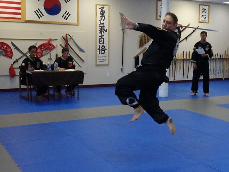 martial arts for adults instructor with a martial arts weapon in a tournament