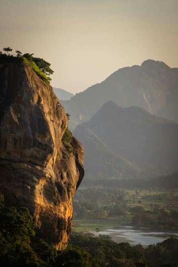 Golden sunrise over the mountains of Sri Lanka with dramatic landscapes and warm morning light.