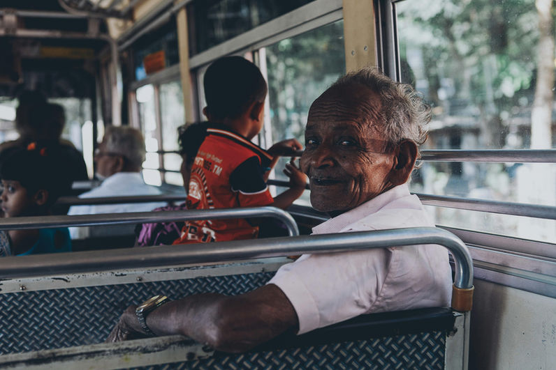 Smiling local passenger travelling on a Sri Lankan train during an authentic cultural travel experience.