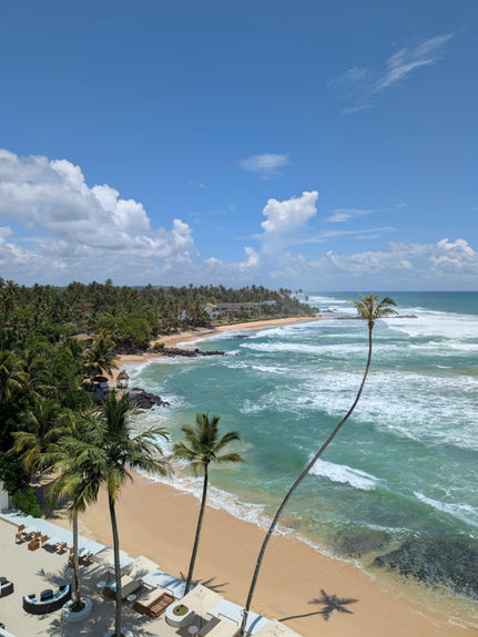 Aerial view of a tropical beach and turquoise coastline in southern Sri Lanka