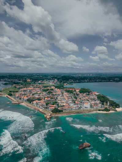 Aerial view of Galle Fort and the southern coastline of Sri Lanka surrounded by turquoise ocean waves.