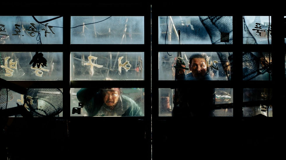 Two men peer through frosted window panes with Korean writing, one lifting a hand in a dim, tense scene.