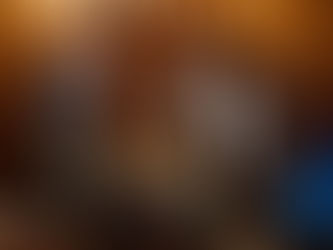 Two singers perform energetically on stage under bright lights. A banner with text is visible in the background, creating a lively atmosphere.