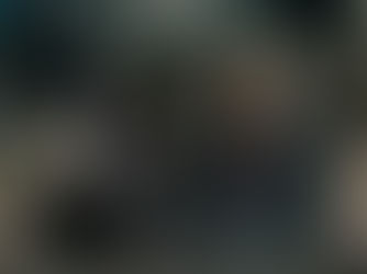 Two people sitting under a geodesic dome at night, one in a hoodie, the other in a plaid jacket, sharing a warm, thoughtful moment.