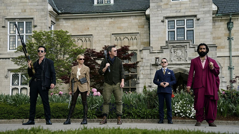 Five people stand confidently with weapons in front of a stone mansion; one wears a bright pink suit. Greenery and flowers surround them.