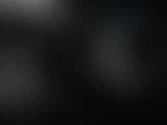 A figure in a dark outfit and goggles crouches on a ledge at night. A building and a billboard are in the background, creating a mysterious mood.