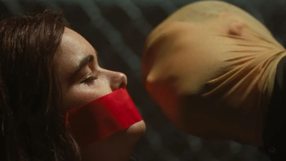 A person with taped mouth faces an individual in a nylon mask in a dim setting. Tension is evident.