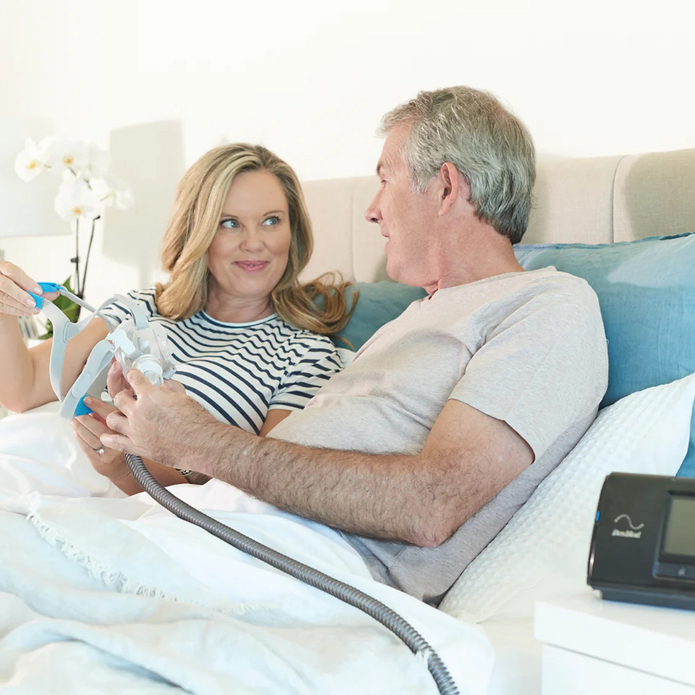 women_man_in_bed_with_CPAP_therapy