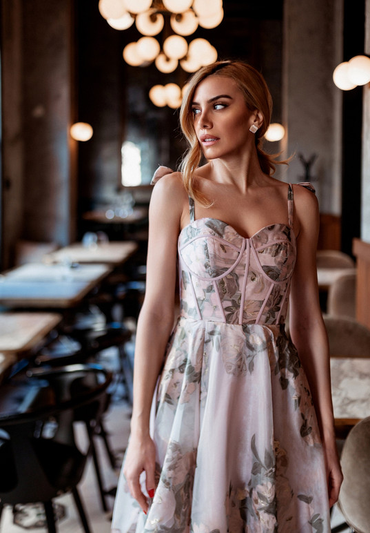 A woman wearing a gorgeous floral print long gown in hues of pink, greens and a slight touch of gold. Exposed corsetry enhances any shape with a flattering sweetheart neckline and narrow straps and a lace-up back. Plus a hidden front split to add a little bit of sophisticaton.
SIZES: 2 - 30
COLOURS: Pink/Green/Gold
SHOWN IN: Pink/Green/Gold