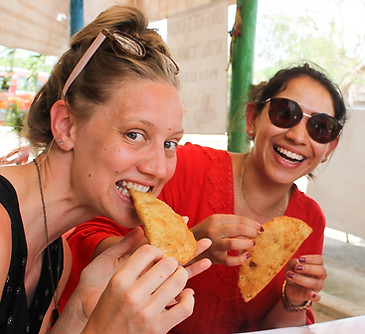 3 people eating empanadas at a local restaurant during a soul trip