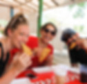 3 people eating empanadas at a local restaurant during a soul trip