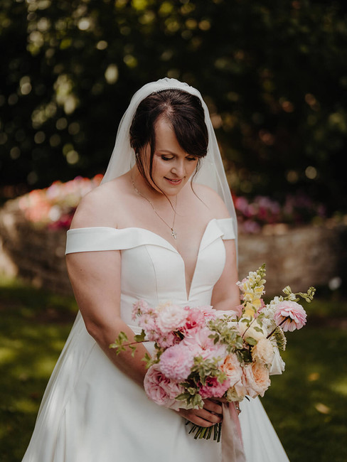 a bride holding a beautiful, colourful bridal bouquet