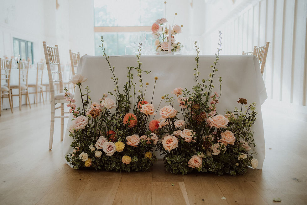 textural wedding reception flowers styling the ends of long guest tables