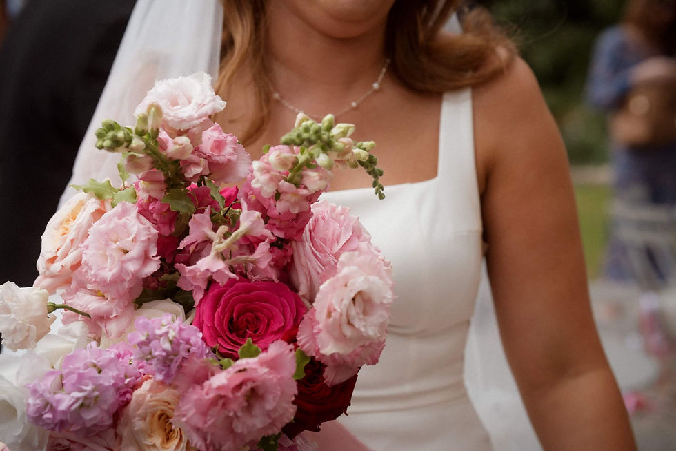 a beautiful pink and red bridal bouquet held by a bride