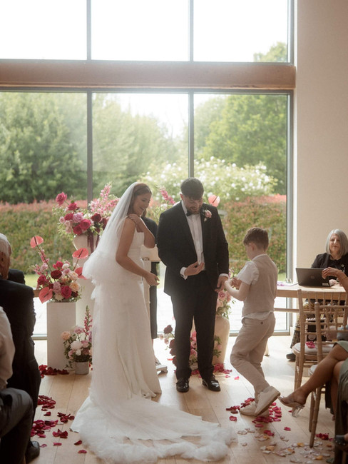 a wedding ceremony featuring modern pink and red wedding flowers