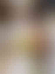 A bride holdig a beautiful, modern bridal bouquet incorporating flowers in yellow, white and orange colour palette