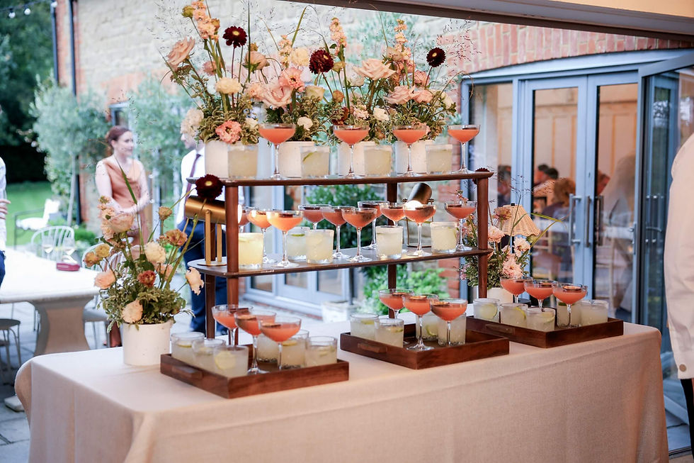 a drink station at Millbridge Court decorated with beautiful flowers in a soft, autumnal colour palette