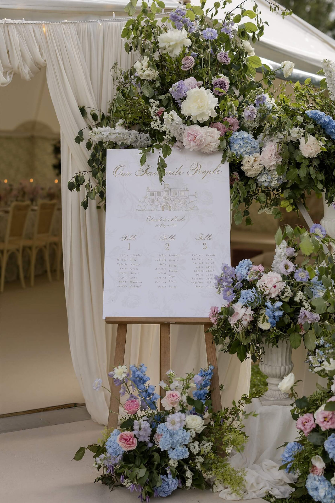 modern wedding seating plan surrounded by beautiful, romantic flowers
