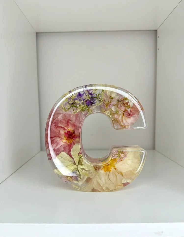 flowers preserved in resin in the letter 'C'