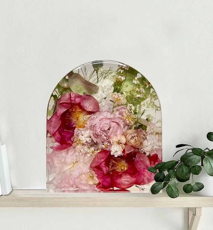 pink flowers preserved in a resin arch