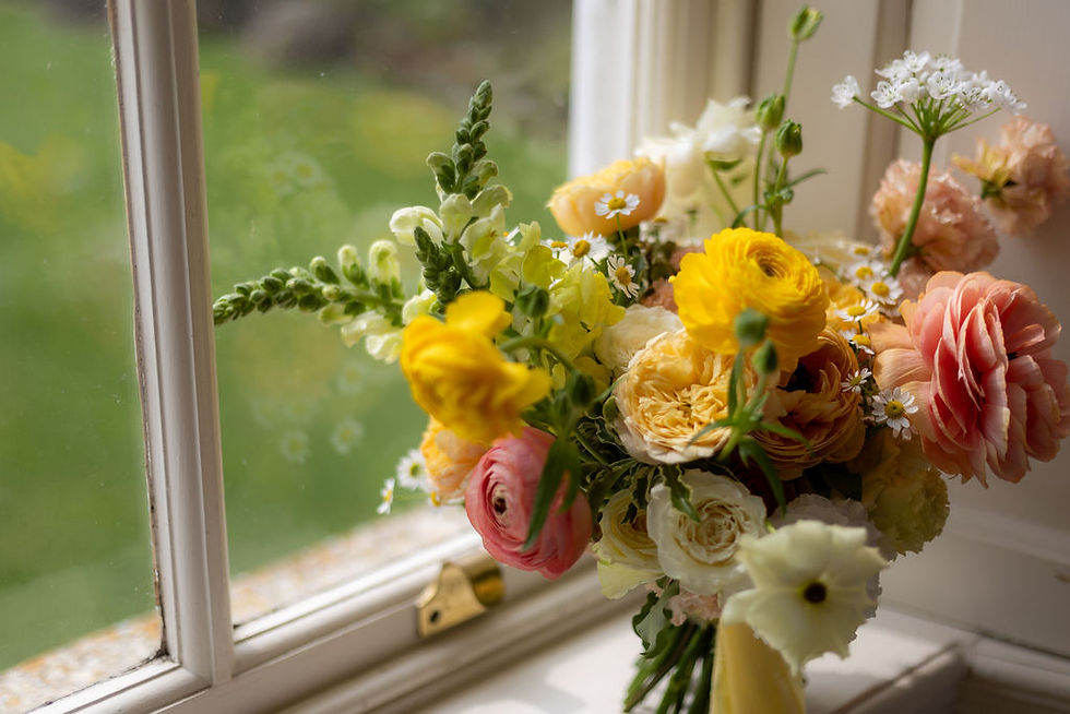 Modern bridal bouquet incorporating beautiful, textural flowers in white, yellow and orange