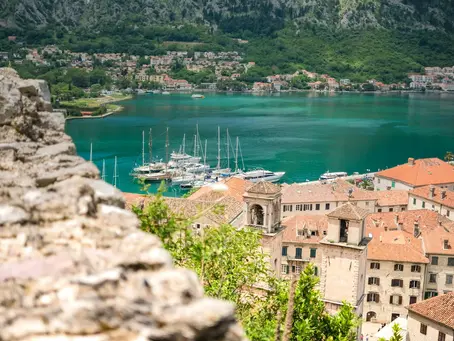 Scenic view of the old town buildings and the turquoise bay of Kotor in Montenegro.