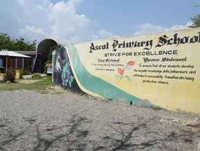 The school gate wall of the Ascot Primary School in Portmore, Jamaica. It states the name of the school, its motto ' Strive for Excellence' and its Mission & Vision Statement.