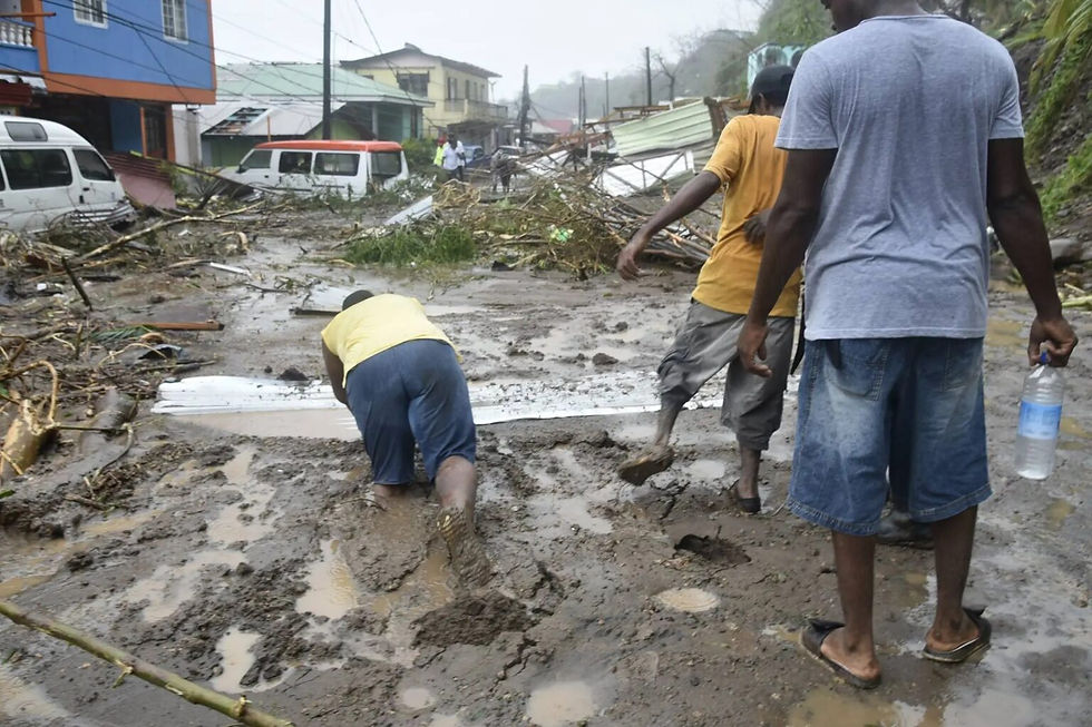 Residents in Dominica attempt to navigate thick layers of mud after the passage of Hurricane Maria in 2017. (Photo: CARICOM Today)