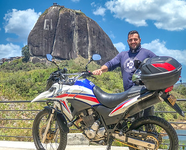 Honda XRE300 motorcycle with rider at El Peñol Rock, Guatapé, Colombia.