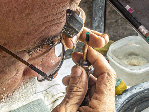 Rider checking emeralds on motorcycle tour Colombia.