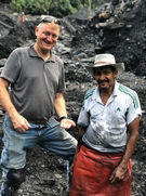Tourist showing emeralds on Medellín motorcycle rental ride.