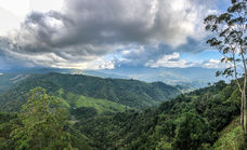 Panoramic green mountains and misty clouds in Colombian Andes.