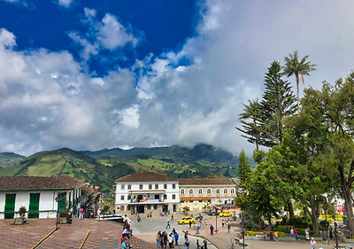 Colonial main plaza of Sonsón, Antioquia, with wax palms and Andean mountains — Day 1 overnight stop on the 10-day Colombia motorcycle tour