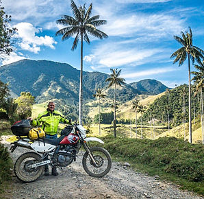 Medellín motorcycle rental riders touring Colombia’s Coffee Region with wax palm trees.