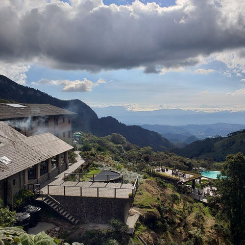 Andean mountain lodge with hot spring pool overlooking dramatic valleys in Colombia.