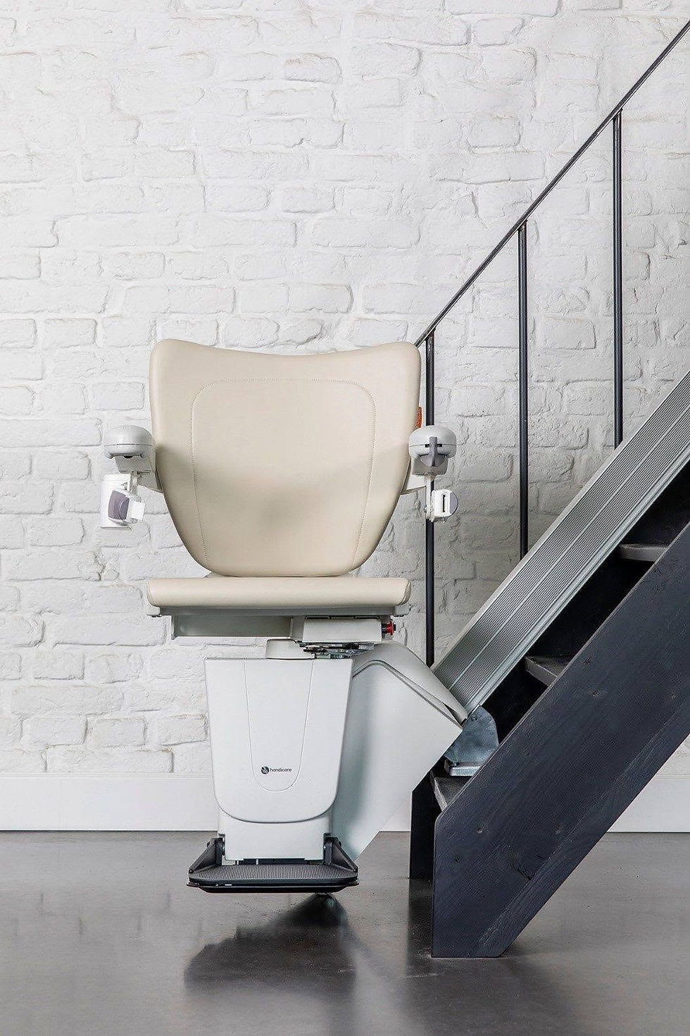A stairlift on a carpeted staircase in a home.