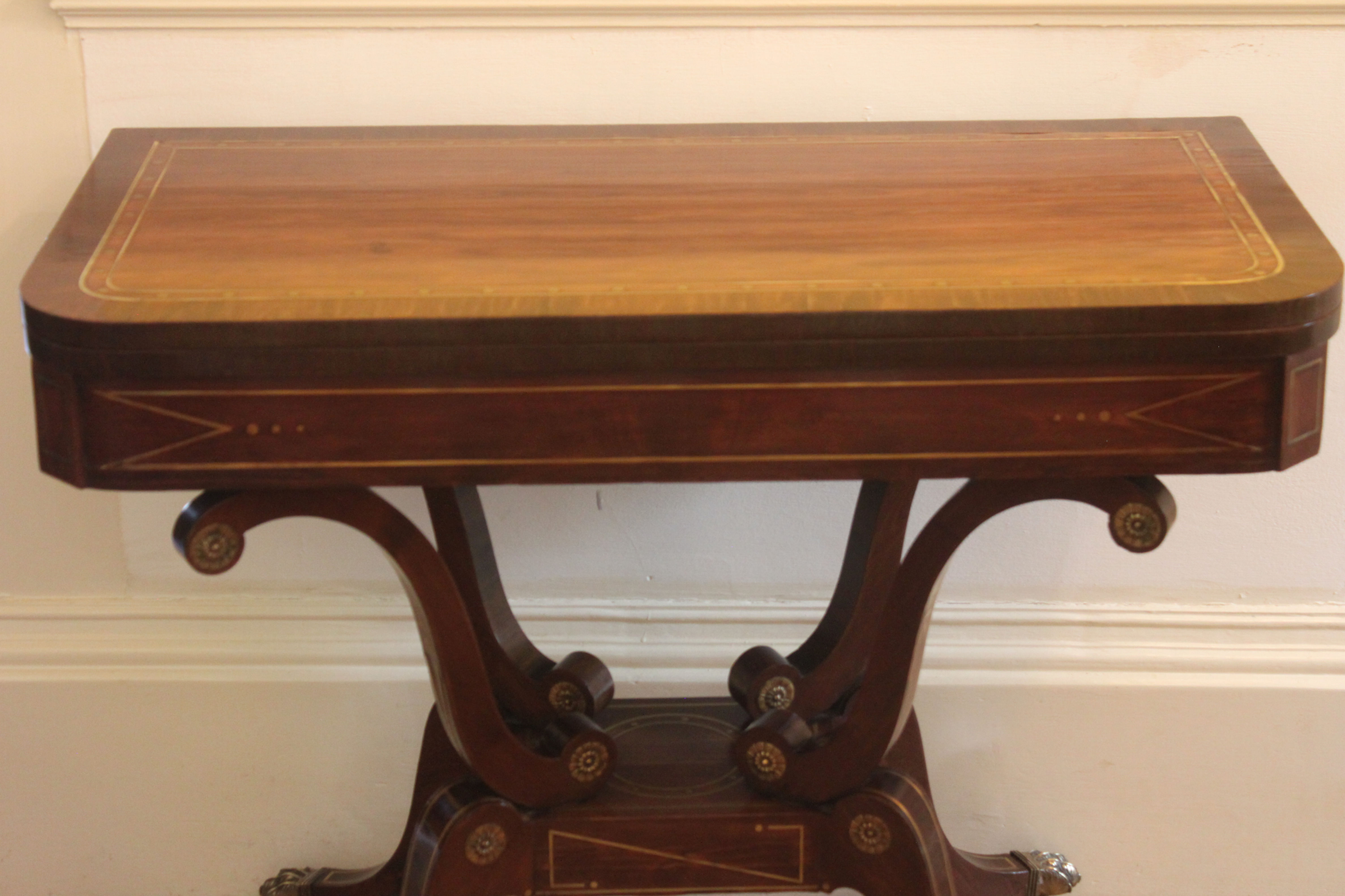 A fine Regency period mahogany brass inlaid fold-over card table