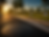 Manhole cover on road with numbered blocks at sunrise