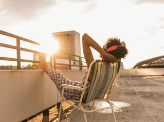 Someone leaning on a lawn chair, while relaxing and listening to music