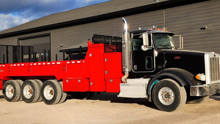 black and red well-drilling truck