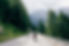 Professional road cyclist on fast and light carbon bicycle descends mountain road in Alps