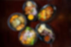 Colorful mix of traditional Peruvian plates like ceviche, lomo saltado, arroz chaufa, and papa a la huancaína displayed on a