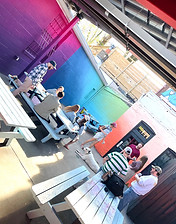 A group of friends with a cute dog enjoying the Purple Quarters patio.