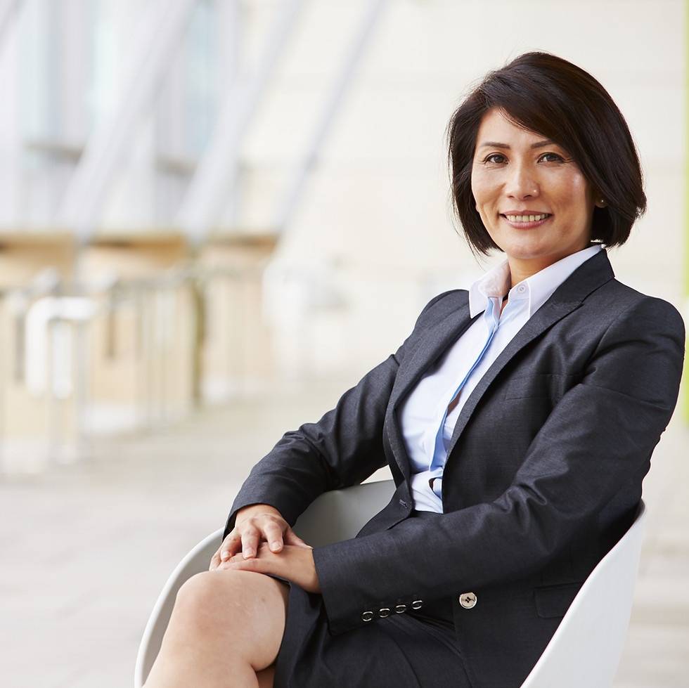 Portrait of smiling Asian businesswoman, sitting.jpg