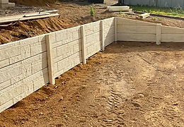Panel and post retaining wall